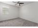 A bright bedroom with a neutral color scheme and a window providing natural light at 9303 E Static Ave, Mesa, AZ 85212