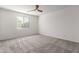 A bright bedroom with natural light, a ceiling fan, and a neutral carpet at 9303 E Static Ave, Mesa, AZ 85212