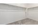 Bright walk-in closet featuring neutral carpet and white shelving at 9303 E Static Ave, Mesa, AZ 85212