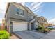 Gray two-story home with a white garage door and minimalist landscaping at 9303 E Static Ave, Mesa, AZ 85212