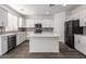 Bright kitchen with white cabinetry, stainless steel appliances, and gray backsplash at 9303 E Static Ave, Mesa, AZ 85212