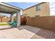 This home features a brick patio, low-maintenance landscaping, and a covered seating area at 9303 E Static Ave, Mesa, AZ 85212