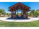 Open-air community pavilion with a unique design providing shade and a gathering place in a landscaped area at 9303 E Static Ave, Mesa, AZ 85212