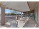 Covered back patio with outdoor seating and views of the low-maintenance desert landscape at 9817 W Loma Blanca Dr, Sun City, AZ 85351