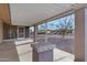 Covered back porch featuring a brick column and a view of the desert landscaping at 9817 W Loma Blanca Dr, Sun City, AZ 85351