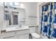 Bathroom with a vanity, sink, toilet, and a shower with a blue patterned curtain at 9817 W Loma Blanca Dr, Sun City, AZ 85351