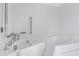 Bathroom featuring a walk-in tub with grab bars for safety and accessibility at 9817 W Loma Blanca Dr, Sun City, AZ 85351