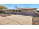 Front exterior view of home featuring desert landscaping, a front porch, two-car garage and long driveway at 9817 W Loma Blanca Dr, Sun City, AZ 85351