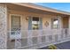 Close-up of front porch with decorative railing, blue shutters, and a security door at 9817 W Loma Blanca Dr, Sun City, AZ 85351