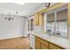 Well-lit kitchen with ample counter space, white appliances, and a view to the outside at 9817 W Loma Blanca Dr, Sun City, AZ 85351