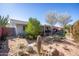 A backyard landscaped with desert plants and a covered patio at 9834 W Evergreen Dr, Sun City, AZ 85373