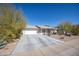 Single-story home with a well-maintained front yard, desert landscaping, and a two-car garage at 9834 W Evergreen Dr, Sun City, AZ 85373