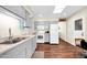 Bright kitchen with modern appliances, light gray cabinets, wood floors, and a skylight for plenty of natural light at 9834 W Evergreen Dr, Sun City, AZ 85373