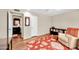 A cozy living room with a recliner, bookcase, and bright red area rug at 9834 W Evergreen Dr, Sun City, AZ 85373