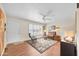 Bright living room featuring hardwood floors, comfortable seating, and large windows with plantation shutters at 9834 W Evergreen Dr, Sun City, AZ 85373