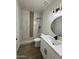 The bathroom features a custom shower with white and wood-look tile and a white vanity at 10281 W Concordia Dr, Arizona City, AZ 85123