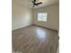 An empty bedroom has wood-look flooring, white walls and a ceiling fan at 10281 W Concordia Dr, Arizona City, AZ 85123