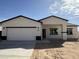 A bright, modern single-Gathering home with a white exterior, dark trim, and a two-car garage at 10281 W Concordia Dr, Arizona City, AZ 85123