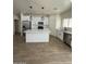 A modern kitchen featuring white cabinets, stainless steel appliances, and a large center island at 10281 W Concordia Dr, Arizona City, AZ 85123