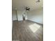 Bright living area with ceramic wood-look tile floors, recessed lights, and a ceiling fan at 10281 W Concordia Dr, Arizona City, AZ 85123