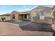 Backyard with a gravel area, patio with an outdoor fireplace, and desert landscaping at 10778 W Whitehorn Way, Peoria, AZ 85383