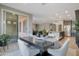 Bright dining area with a modern table and chairs, seamlessly connected to the kitchen and living area at 10778 W Whitehorn Way, Peoria, AZ 85383