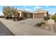 Charming home features a neutral stucco exterior, tile roof, manicured bushes, and a concrete driveway leading to a two-car garage at 10778 W Whitehorn Way, Peoria, AZ 85383