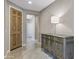 Inviting foyer with decorative console table, overhead lighting, tile flooring, and a wooden front door at 10778 W Whitehorn Way, Peoria, AZ 85383