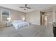 Spacious main bedroom featuring neutral colors, carpet flooring, a ceiling fan, and a conveniently located en suite at 10778 W Whitehorn Way, Peoria, AZ 85383