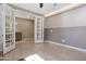 Open sitting area with neutral paint, tiled flooring, and double doors providing access to an office space at 10778 W Whitehorn Way, Peoria, AZ 85383