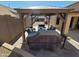 Covered patio featuring an outdoor kitchen and dining area with wood pergola at 11460 E Dartmouth St, Mesa, AZ 85207