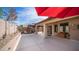 A beautiful backyard and patio with a covered seating area and lush landscaping at 11460 E Dartmouth St, Mesa, AZ 85207