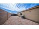 Low maintenance backyard with gravel covering; AC unit adjacent to house at 11460 E Dartmouth St, Mesa, AZ 85207