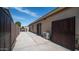 View of a fenced backyard with a concrete patio and exterior wall AC unit at 11460 E Dartmouth St, Mesa, AZ 85207