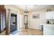 Dining area near the kitchen featuring a chandelier and sliding glass doors to the backyard at 11460 E Dartmouth St, Mesa, AZ 85207