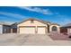 Lovely home featuring a 2-car garage, a large driveway, and desert landscaping at 11460 E Dartmouth St, Mesa, AZ 85207