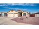 Beautiful home with a large driveway, two-car garage, and desert landscaping at 11460 E Dartmouth St, Mesa, AZ 85207