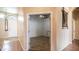 Inviting hallway featuring warm paint, high ceilings, decorative mirror, and doorways that give a peek into other rooms at 11460 E Dartmouth St, Mesa, AZ 85207