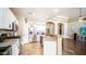 View of the kitchen showcasing stainless steel appliances, white cabinets, and breakfast bar at 11460 E Dartmouth St, Mesa, AZ 85207