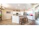 Kitchen featuring a breakfast bar, white cabinetry, stainless steel appliances, and tile flooring at 11460 E Dartmouth St, Mesa, AZ 85207