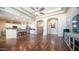 View of living room showcasing wood floors, spacious layout, and seamless flow to the kitchen at 11460 E Dartmouth St, Mesa, AZ 85207