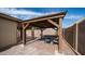 Paver patio with wood pergola structure and outdoor seating and dining areas at 11460 E Dartmouth St, Mesa, AZ 85207