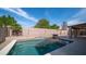 A beautiful backyard pool with a waterfall feature and lush landscaping around the perimeter at 11460 E Dartmouth St, Mesa, AZ 85207