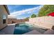 Inviting backyard pool with a waterfall feature and an adjacent seating area under an umbrella at 11460 E Dartmouth St, Mesa, AZ 85207