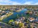 Aerial view of waterfront homes on a large lake with a backdrop of mountains on the horizon at 1157 N Date Palm Dr, Gilbert, AZ 85234