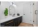 Well-lit bathroom showcasing a vanity with black cabinets, gold hardware, and a large mirror at 1157 N Date Palm Dr, Gilbert, AZ 85234