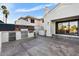 Outdoor kitchen area with stainless steel grill, refrigerator, and counterspace on a spacious back patio at 1157 N Date Palm Dr, Gilbert, AZ 85234