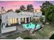 Aerial view of backyard pool area, rock features, lush landscaping and water view at 1157 N Date Palm Dr, Gilbert, AZ 85234