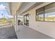 Spacious covered back patio with a lounge chair and space for outdoor entertaining at 12434 W Fieldstone Dr, Sun City West, AZ 85375