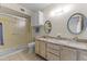 This bathroom showcases a dual-sink vanity, tiled flooring, and a framed shower with a glass door at 12434 W Fieldstone Dr, Sun City West, AZ 85375